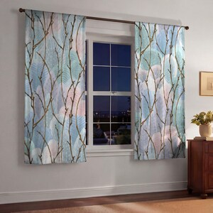 a window with a view of a city skyline, and the curtains have a leafy, tree-like pattern in shades of blue, green, and white.