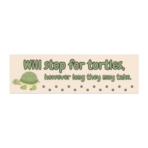 May include: A rectangular sign with the text "Will stop for turtles, however long they may take." A cartoon turtle is on the left. The sign is beige with green and gray accents.