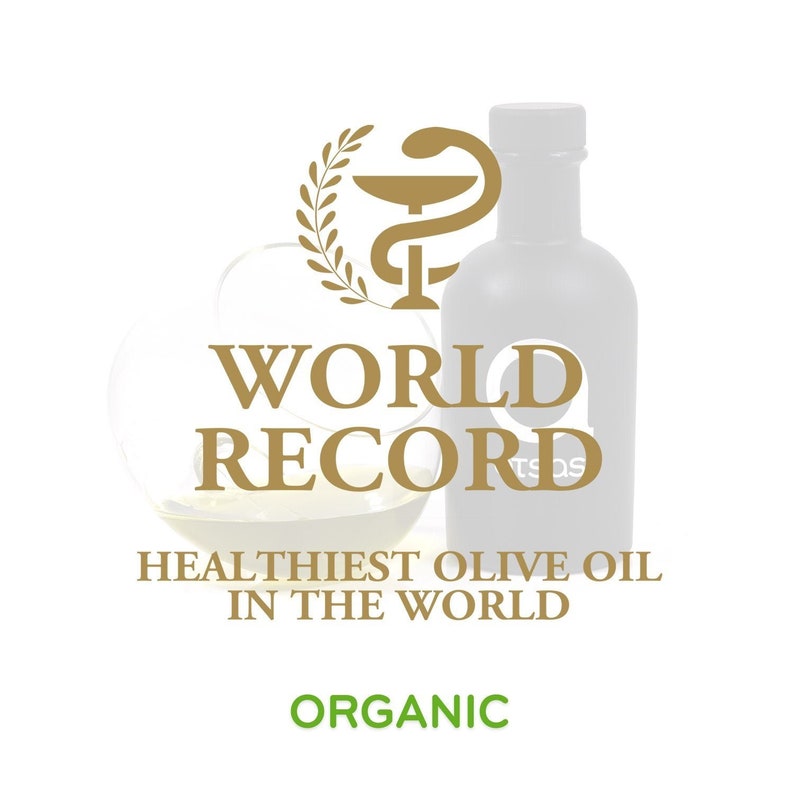 Puede incluir: Una botella de vidrio de aceite de oliva con una etiqueta dorada que dice "R&eacute;cord mundial Aceite de oliva m&aacute;s saludable del mundo" y "Org&aacute;nico". La botella est&aacute; delante de un s&iacute;mbolo m&eacute;dico dorado con una corona de laurel.