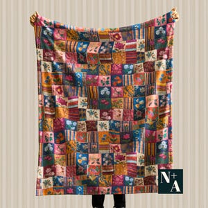 May include: A colorful patchwork quilt with a variety of floral and striped patterns. The quilt features squares in shades of blue, pink, orange, and green. The quilt is held up by two hands, showcasing its size and design. The quilt is a cozy home decor item.