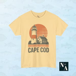Cape Cod lighthouse graphic tee in yellow with vintage 80s coastal design and nostalgic fisherman aesthetic