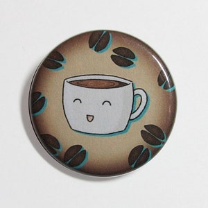 May include: A brown and white button with a cartoon coffee cup with a smiling face and coffee beans around it.