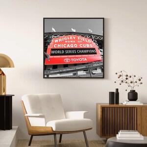 May include: A black and white photograph of Wrigley Field, home of the Chicago Cubs, with a red sign that reads "Wrigley Field, Home of Chicago Cubs, World Series Champions, Toyota".
