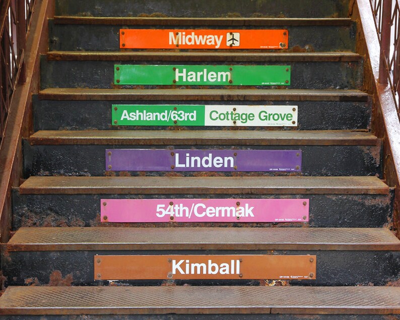 May include: A set of six signs with the names of Chicago 'L' train stations: Midway, Harlem, Ashland/63rd, Cottage Grove, Linden, 54th/Cermak, and Kimball. The signs are attached to the steps of a staircase.