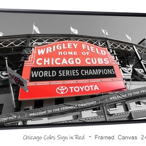 May include: A black and white photo of Wrigley Field, home of the Chicago Cubs, with a red sign that reads "Wrigley Field, Home of Chicago Cubs, World Series Champions, Toyota".