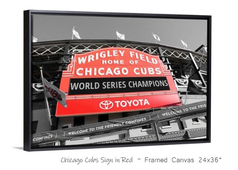 May include: A black and white photo of Wrigley Field, home of the Chicago Cubs, with a red sign that reads "Wrigley Field, Home of Chicago Cubs, World Series Champions, Toyota".