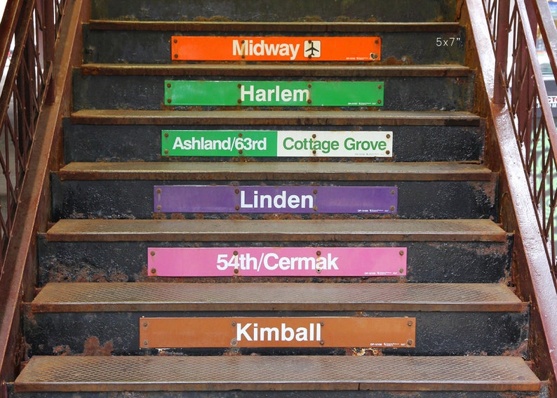 May include: A set of six rusty metal steps with signs indicating different Chicago 'L' train stops. The signs are in various colors, including orange, green, white, purple, pink, and brown. The signs read: Midway, Harlem, Ashland/63rd Cottage Grove, Linden, 54th/Cermak, and Kimball.