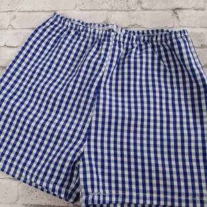 May include: Blue and white gingham shorts with a wide elastic waistband.