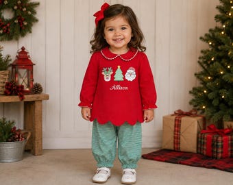 May include: A red long-sleeved top with a scalloped hem and a white Peter Pan collar, featuring embroidered reindeer, Christmas tree, and Santa Claus icons with the name Allison. Paired with green and white striped trousers.