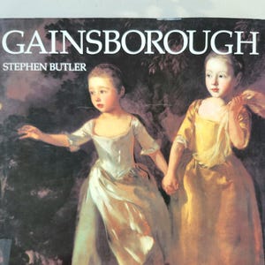 May include: A book cover with the title "GAINSBOROUGH" and the author "STEPHEN BUTLER". The cover features a painting of two young girls in white and yellow dresses, standing in a garden setting.