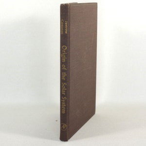 May include: A brown hardcover book with gold lettering on the spine. The title is "Origin of the Solar System" by Jastrow and Cameron. The book is published by Prentice-Hall.