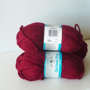 May include: Two skeins of deep red yarn labeled "Eaton Luxury Fair Shetland Style Chunky" with a color code of 4961 and lot number 251.