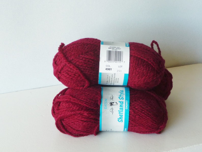 May include: Two skeins of deep red yarn labeled "Eaton Luxury Fair Shetland Style Chunky" with a color code of 4961 and lot number 251.