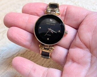 Vintage Working Anne Klein Gold Tone Cuff Watch with Black Dial and Black Panels on Band