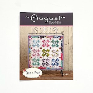 May include: A quilt pattern booklet featuring a colorful quilt with a floral design. The booklet is titled "August - Make-It-Mini" and includes the text "This & That" and "#276".