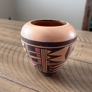 May include: A set of three ceramic mugs with a speckled, matte finish. The mugs are in shades of cream, light brown, and dark brown. Each mug has a simple, minimalist design, perfect for coffee or tea.