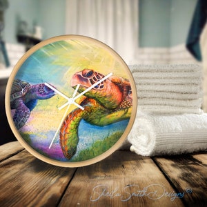 May include: A round wooden clock with a colorful painting of two sea turtles. The turtles are facing each other and appear to be swimming in a vibrant underwater scene. The clock face is white with black hands.