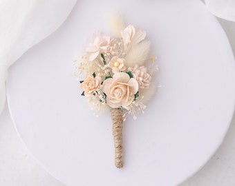 Boutonniere for the groom with dried flowers. Peach and blush pink buttonhole. Corsage for groomsman and best man, flower boutonniere