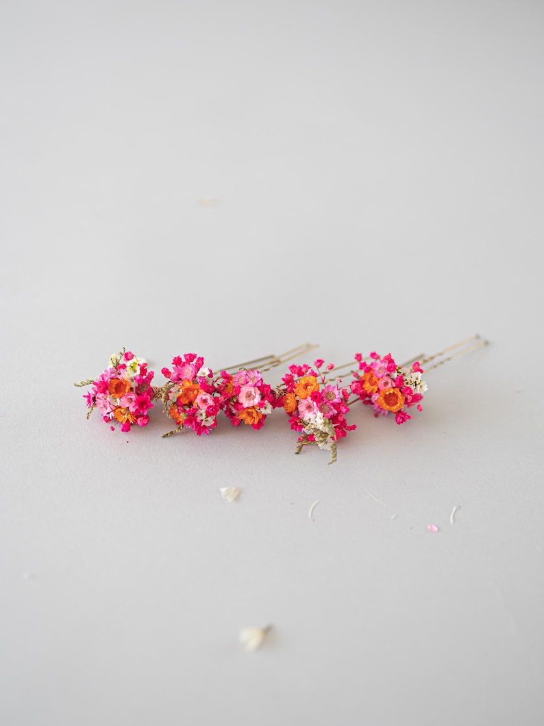 Handgefertigte Haarnadeln mit konservierten Blumen, darunter zarte Gänseblümchen und Schleierkraut in Orange, rosa und pink. Diese romantischen Haarblumen in warmen Herbstfarben sind ein vielseitiger Haarschmuck für Boho-Styles und natürliche Looks. Perfekt als bunter Haarschmuck mit Wildblumen und Schleierkraut für Sommerfeste, Oktoberfest, Hochzeiten, Weihnachten, Brautpartys, Geburtstage, Babypartys. Ideal als herbstliche Accessoires, Haarklammern.