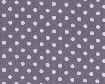 White polka dot cotton fabric on a grey background