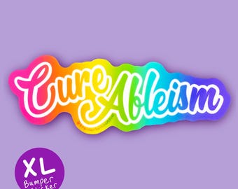 May include: A rainbow-coloured bumper sticker with the words "Cure Ableism" in a cursive font. The sticker has a white outline and is on a purple background. A purple circle with the text "XL Bumper Sticker" is in the lower left corner.