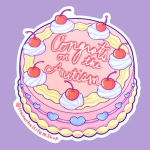 May include: A round sticker featuring a cartoon cake with pink frosting, yellow trim, and white whipped cream dollops topped with cherries. The cake has the text "Congrats on the Autism" in red script. Blue hearts decorate the bottom edge.