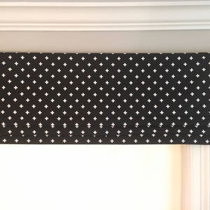 May include: Black and white roman shade with a white plus sign pattern.