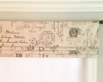 May include: A beige roman shade with a vintage Parisian postmark design. The shade features black text and stamps with French words like "Postes Francaises" and "Par Avion".
