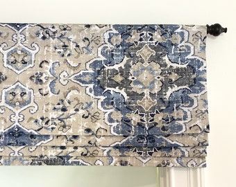 May include: A romantically patterned valance in shades of blue and beige. The valance is made of a soft, textured fabric and has a gathered look.