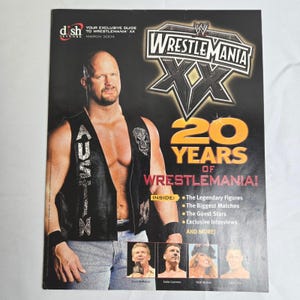 May include: A magazine cover for WrestleMania XX, featuring a wrestler in a black vest with a skull design. The cover includes the text "20 Years of WrestleMania!" and the Dish Network logo. March 2004.