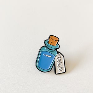Alice in wonderland enamel pin