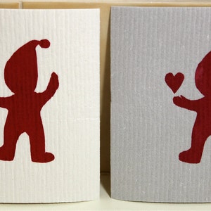 Peut inclure: Deux cartes blanches avec des silhouettes rouges d'une personne tenant un cœur. La personne porte un chapeau et a un design simple et cartoon.