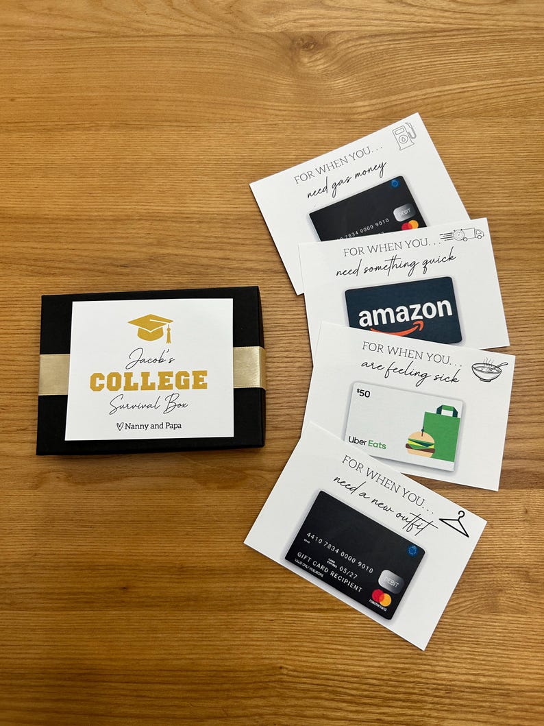 May include: A black gift box with gold accents and the text "Jacob's College Survival Box." Several gift cards are arranged around the box, including Amazon and Uber Eats cards, and a gift card for gas money.