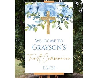 Pode incluir: Um sinal de boas-vindas à Primeira Comunhão de Grayson com um design floral azul e verde e uma cruz dourada com glitter. A data 11.27.24 está impressa abaixo do texto.
