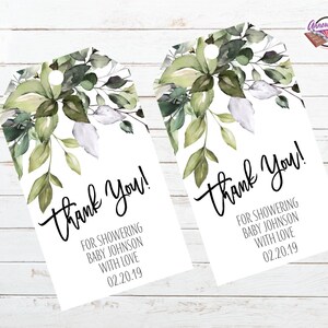 May include: Two white gift tags with a green watercolor floral design. The text on the tags reads "Thank You!" and "For showering Baby Johnson with love 02.20.19".