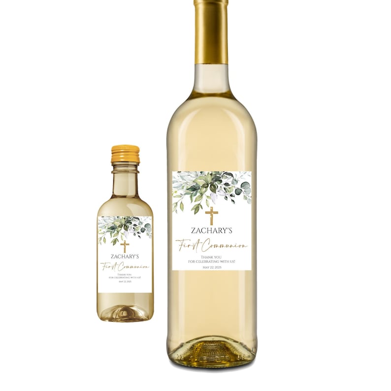 May include: Two wine bottles with labels for a First Communion celebration. The labels feature a gold cross, green leaves, and the text "Zachary's First Communion". The smaller bottle is 375 ml and the larger bottle is 750 ml.