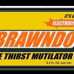 May include: A yellow and orange sign with the text "BRAWNDO THE THIRST MUTILATOR" and "IT'S GOT ELECTROLYTES". The sign also includes the text "8.3 FL. OZ. (per sip)".
