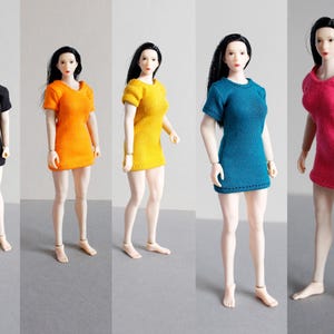 K&ouml;nnte beinhalten: F&uuml;nf 1/6-Ma&szlig;stab-Modepuppen, die verschiedene farbige, kurz&auml;rmelige Kleider tragen. Die Kleider sind schwarz, orange, gelb, t&uuml;rkis und rosa.