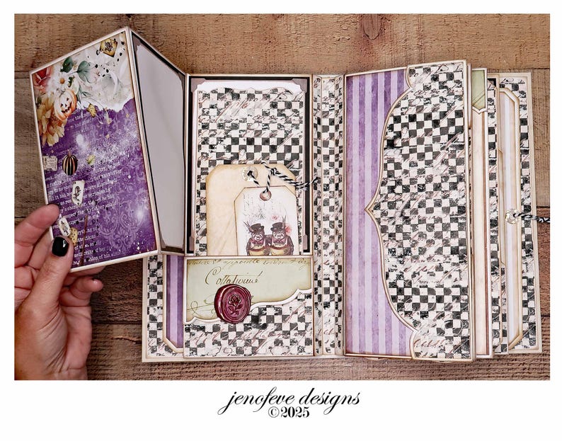May include: An open scrapbook with a purple and floral cover, featuring a checkerboard and striped interior. The pages include tags, a wax seal, and decorative elements. The text "jenofeve designs &copy;2025" is visible.