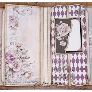 May include: Open scrapbook with floral and diamond pattern designs. The left side features a large arrangement of lavender roses and foliage. The right side has a purple and white diamond pattern with a photo frame and rose accents. The text "jenefeve designs 2023" is visible.