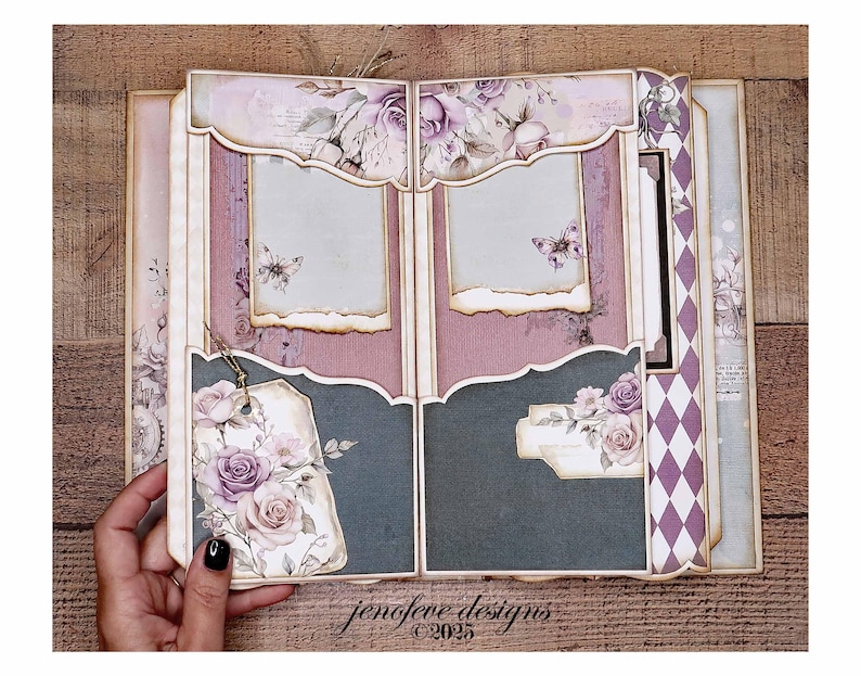 May include: Open scrapbook with a floral design. The pages feature a mix of purple, pink, and gray hues, with decorative elements like roses, butterflies, and tags. The text "jenofeve designs &copy;2025" is visible.