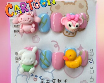 May include: A set of ten pink and blue artificial fingernails with cartoon animal decorations. The decorations include a pink bunny, a pink deer, a white bunny, and a yellow duck. The nails are labeled with the text "CARTOON" and "手工穿戴甲".