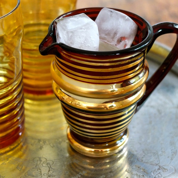 Antique red glass water jug / two amber drinking glasses / red and gold