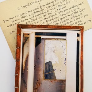 Detail of the outer of a handmade artist book paying homage to the assemblage artist Joseph Cornell. In the background is a complementary post card written to the artist.