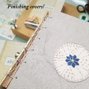 A process shot showing how the covers are finished with a decorative motif that complements the book.