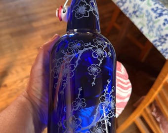 Blue glass cherry blossom  32 ounce swing top bottle