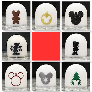 May include: Set of ten white ceramic ornaments with various black and white Disney character silhouettes. The ornaments feature Mickey Mouse, Minnie Mouse, Donald Duck, Goofy, Pluto, and other characters.