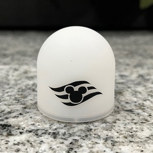 May include: White plastic dome with a black Mickey Mouse head and three wavy lines, the Disney Cruise Line logo.