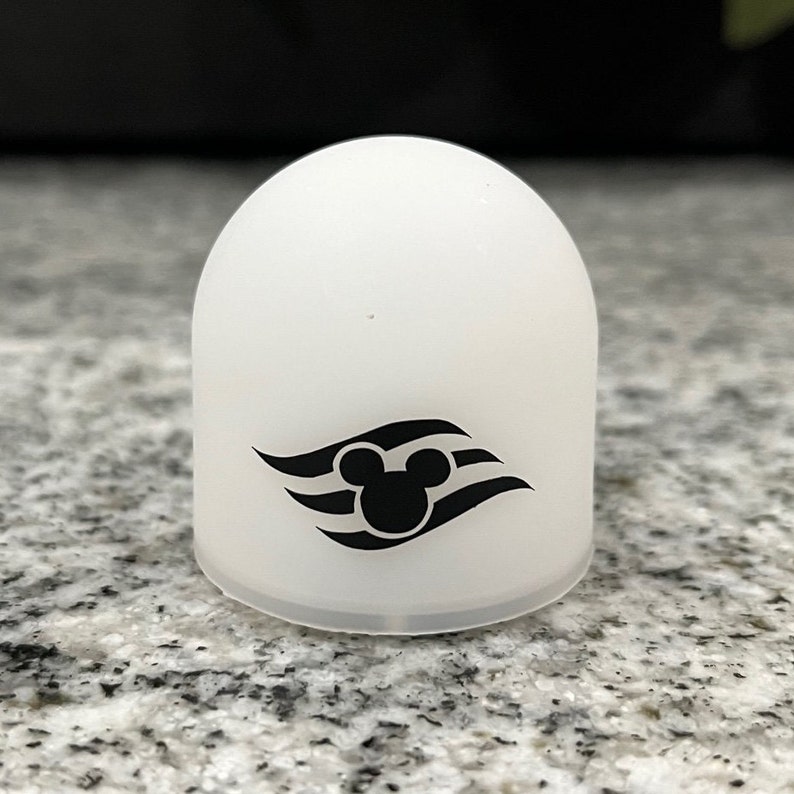 May include: White plastic dome with a black Mickey Mouse head and three wavy lines, the Disney Cruise Line logo.