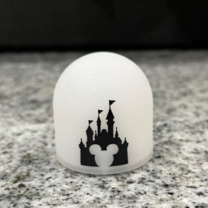 May include: White frosted glass dome with a black silhouette of Cinderella's castle and Mickey Mouse ears.
